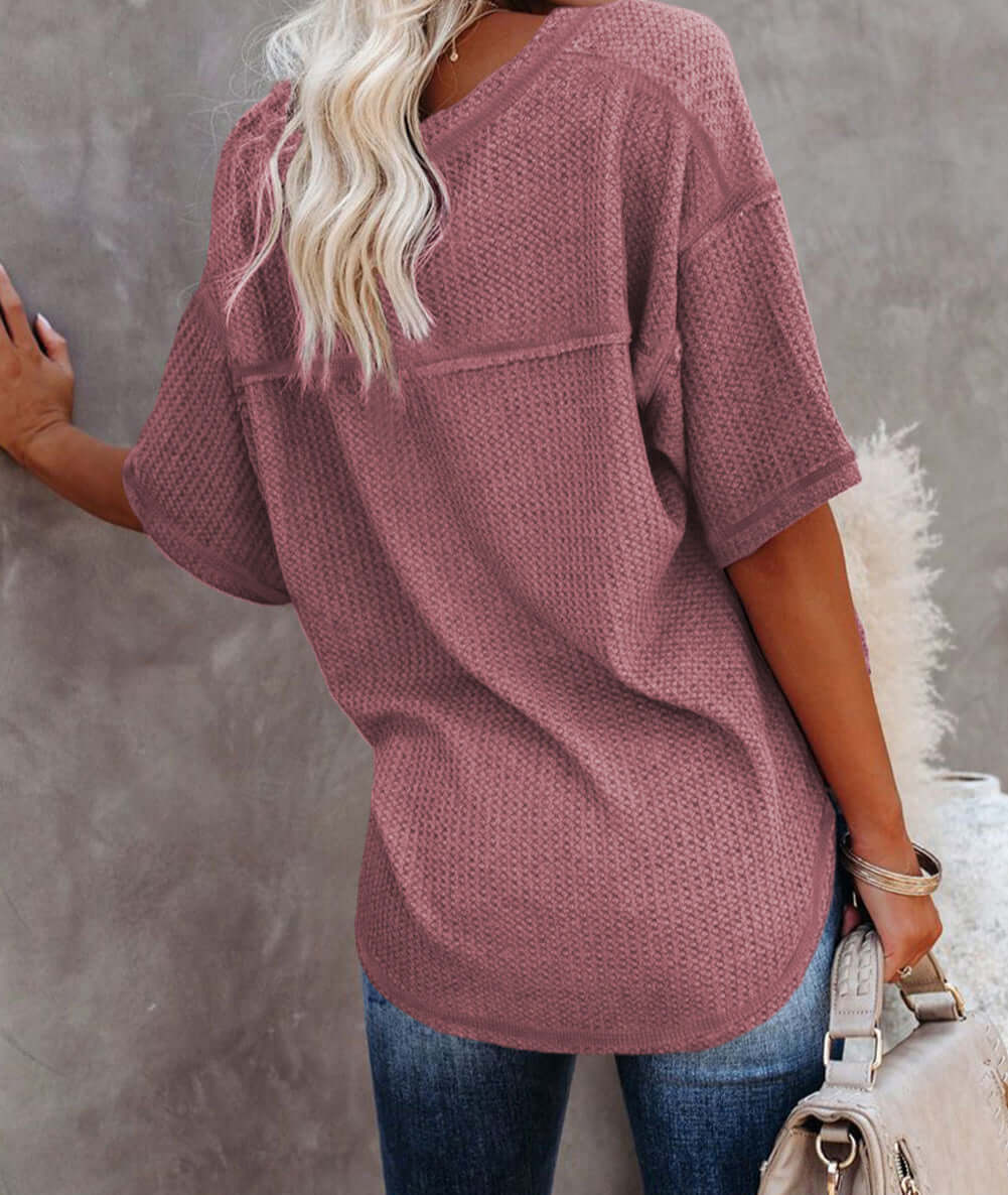 Back view of a woman wearing the Carefree Mode Top in Rosewood, showcasing its relaxed fit and textured knit.