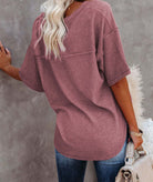 Back view of a woman wearing the Carefree Mode Top in Rosewood, showcasing its relaxed fit and textured knit.