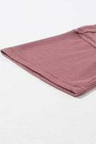 Close-up of Carefree Mode Top in rosewood color, showcasing textured knit fabric and relaxed fit design.