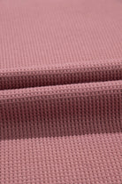 Textured rosewood fabric showcasing soft, breathable knit perfect for relaxed summer clothing.