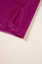 Close-up of Raspberry Gemtone Top with luxurious velvet fabric and pleated texture on a cream background.