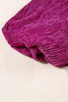 Close-up of the Raspberry Gemtone Top showing pleated velvet texture in vibrant raspberry color.