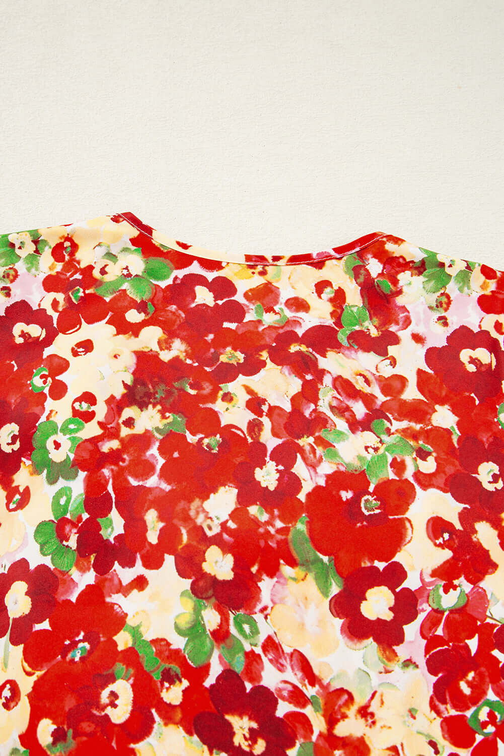 Tropical Tango blouse back view showcasing vibrant red floral print and bubble sleeves.