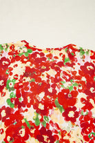 Tropical Tango blouse back view showcasing vibrant red floral print and bubble sleeves.