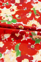 Close-up of vibrant red floral fabric featuring bold blooms for the Tropical Tango blouse.