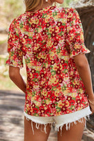 Back view of a vibrant red floral bubble sleeve blouse, perfect for summer with shorts.