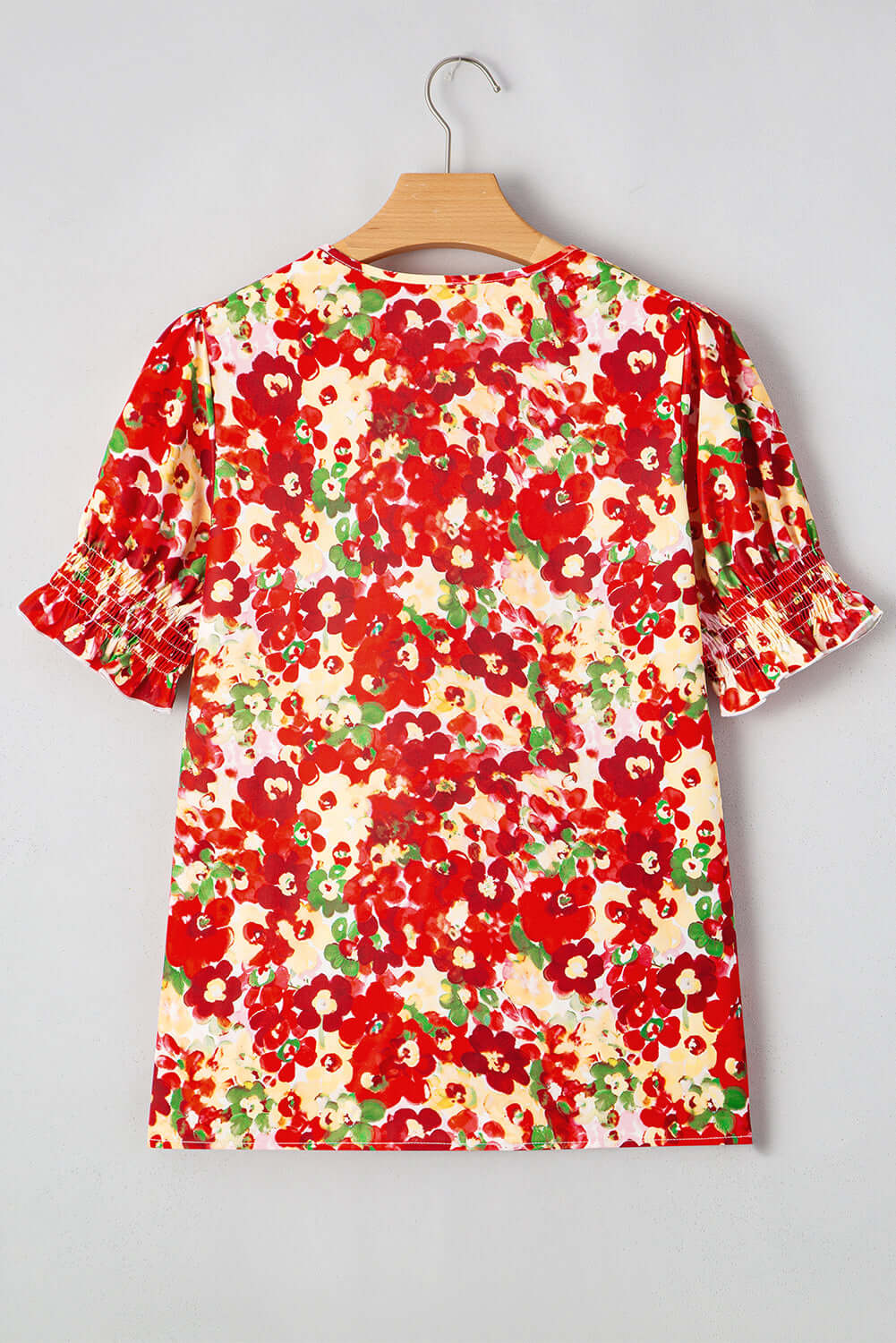 Back view of the Tropical Tango red floral bubble sleeve blouse featuring vibrant colors and flattering design.