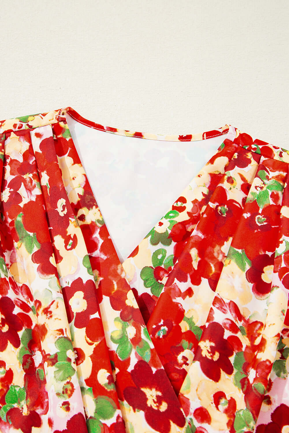 Tropical Tango blouse featuring vibrant red floral print and flattering V-neck design.