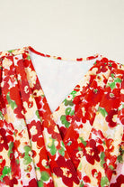 Tropical Tango blouse featuring vibrant red floral print and flattering V-neck design.