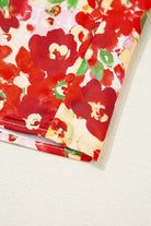 Vibrant red floral fabric close-up showcasing the Tropical Tango blouse's bold design and summer charm.