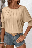 Timeless & Adaptable Blouse - CAUGHT MY ATTENTION TOP by Vivian-Lu $25.00 Unleash style and comfort with our trendy boutique blouse. Soft, stretchy fabric in neutral beige with chic pleats and shirred cuffs. Teal Tiger Boutique