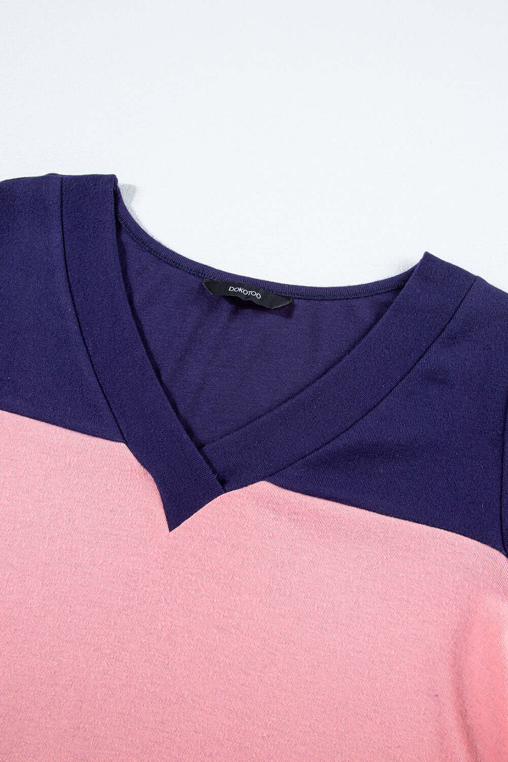 BETTER DAYS Top by Vivian-Lu featuring V-neck design and color blocking in pink and navy. Detail on sleeves visible.