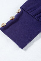 Close-up of the BETTER DAYS Top by Vivian-Lu showcasing button detailing on a navy sleeve.