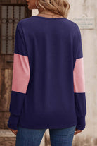 Back view of the BETTER DAYS Top by Vivian-Lu featuring navy and pink color blocking with long sleeves and relaxed fit.