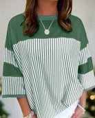 Green striped top with patchwork design and 3/4 sleeves, stylish and cozy for all seasons.