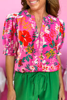 Paradise Petals Top: vibrant rose floral blouse with puff sleeves and split V-neck, perfect for summer style.