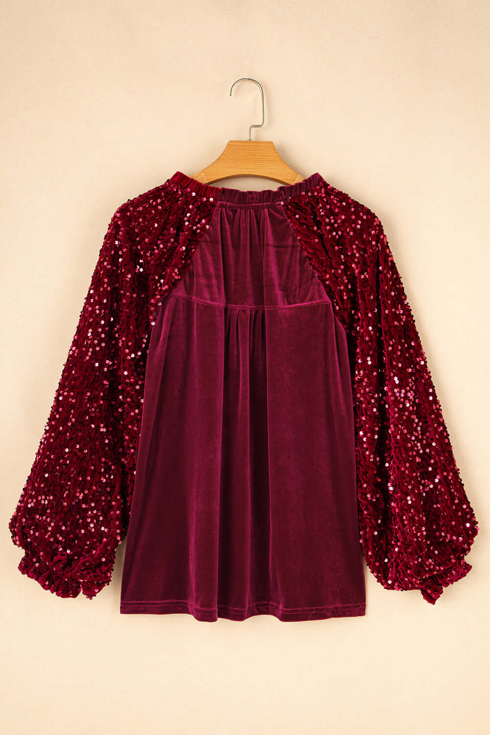 Back view of SEQUIN SIREN velvet top with sequined sleeves and ruffle details, perfect for holiday occasions.