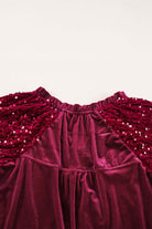 Close-up of SEQUIN SIREN top showcasing velvet fabric and dazzling sequined sleeves in rich burgundy color.