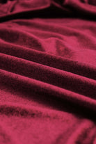 Close-up of luxurious burgundy velvet fabric, showcasing its soft texture and rich color for the SEQUIN SIREN Top.