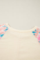 Lightweight vanilla ribbed top with floral patchwork sleeves, featuring an elegant crew neck and banded bottom.