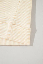 close-up of the ribbed fabric and banded bottom of the VANILLA SKYE TOP in a soft vanilla shade.