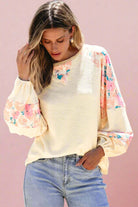 Stylish vanilla top with floral patchwork and balloon sleeves, perfect for a trendy look.