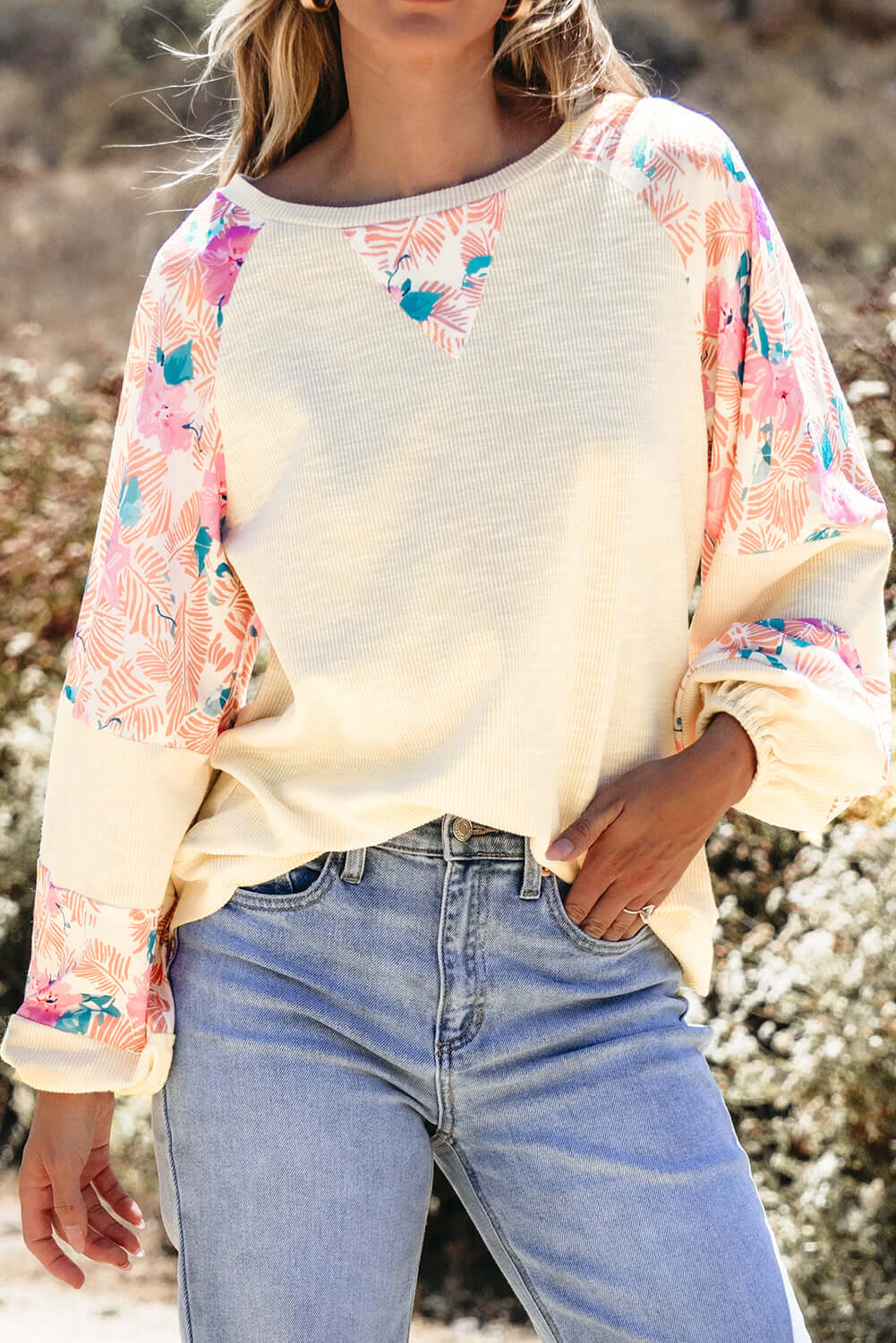 Lightweight vanilla ribbed top with floral patchwork and balloon sleeves, styled with denim jeans.