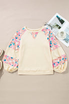 Lightweight vanilla ribbed top with floral patchwork and balloon sleeves, stylish and feminine design.