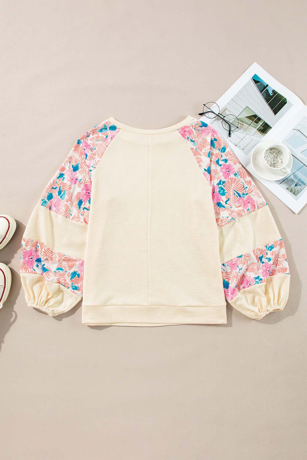 Lightweight vanilla top with floral patchwork balloon sleeves and a classic crew neck. Perfect for stylish casual wear.