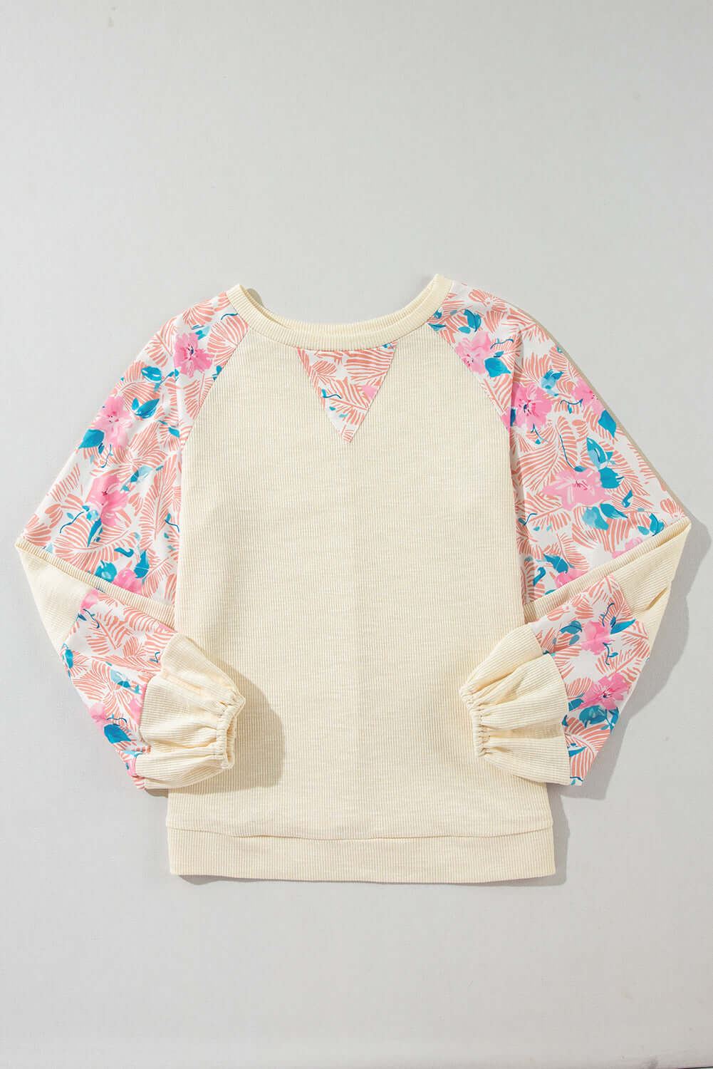 Lightweight vanilla top with floral patchwork sleeves and balloon sleeves for a stylish, feminine look.