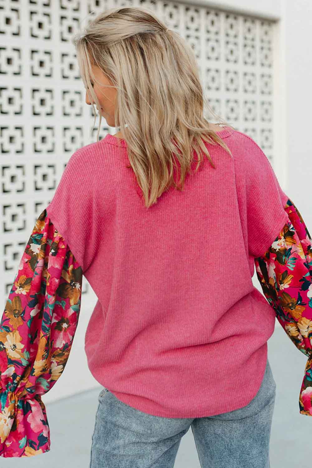 Back view of Petal Perfection knit top with ruffled floral sleeves, showcasing its chic patchwork design.