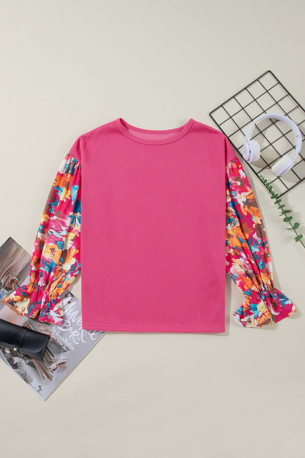 Stylish Petal Perfection knit top featuring vibrant patchwork sleeves and a comfortable drop shoulder design.