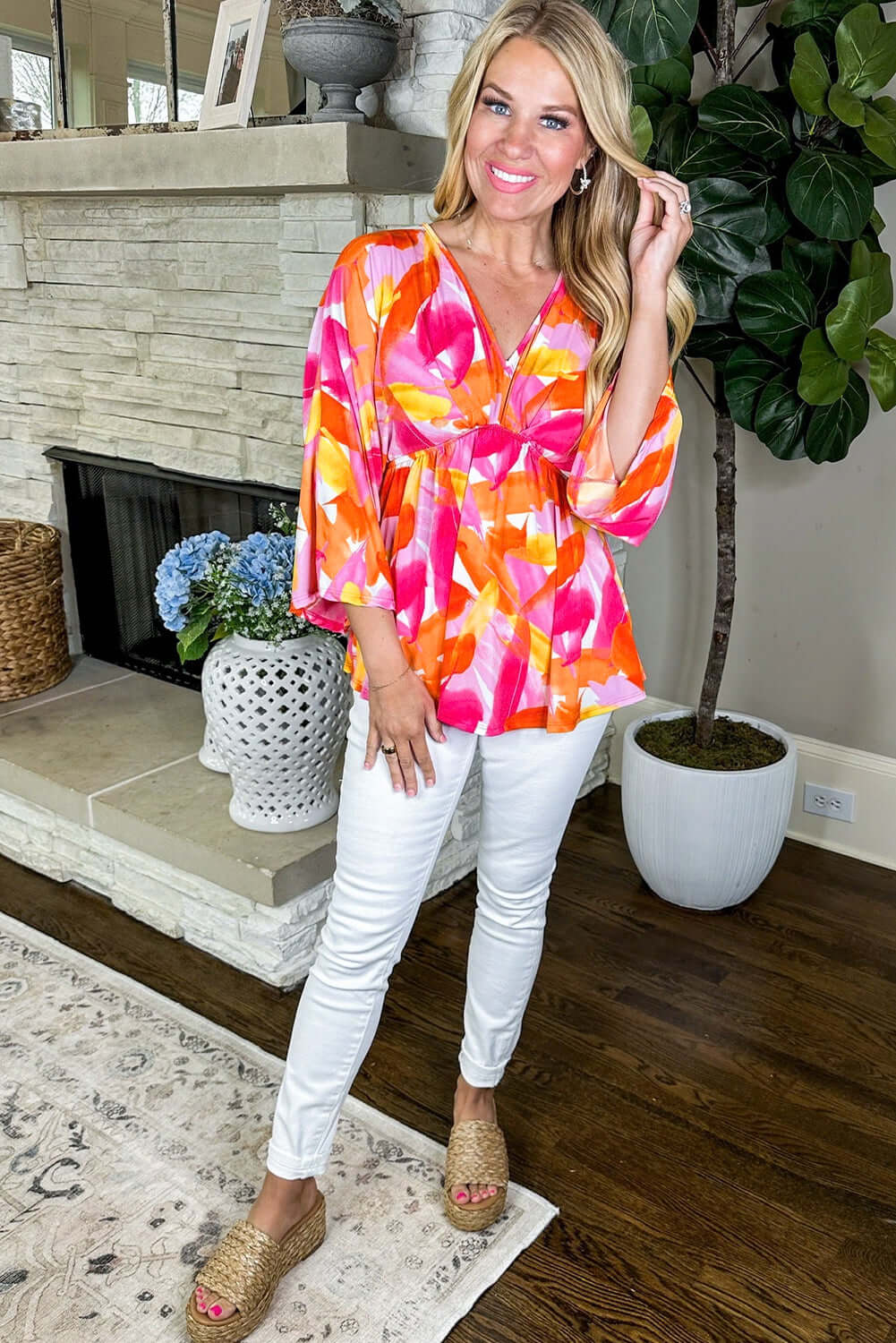 SUNKISSED BABE TOP in vibrant brush stroke design, featuring v-neck and 3/4 sleeves, paired with white pants.