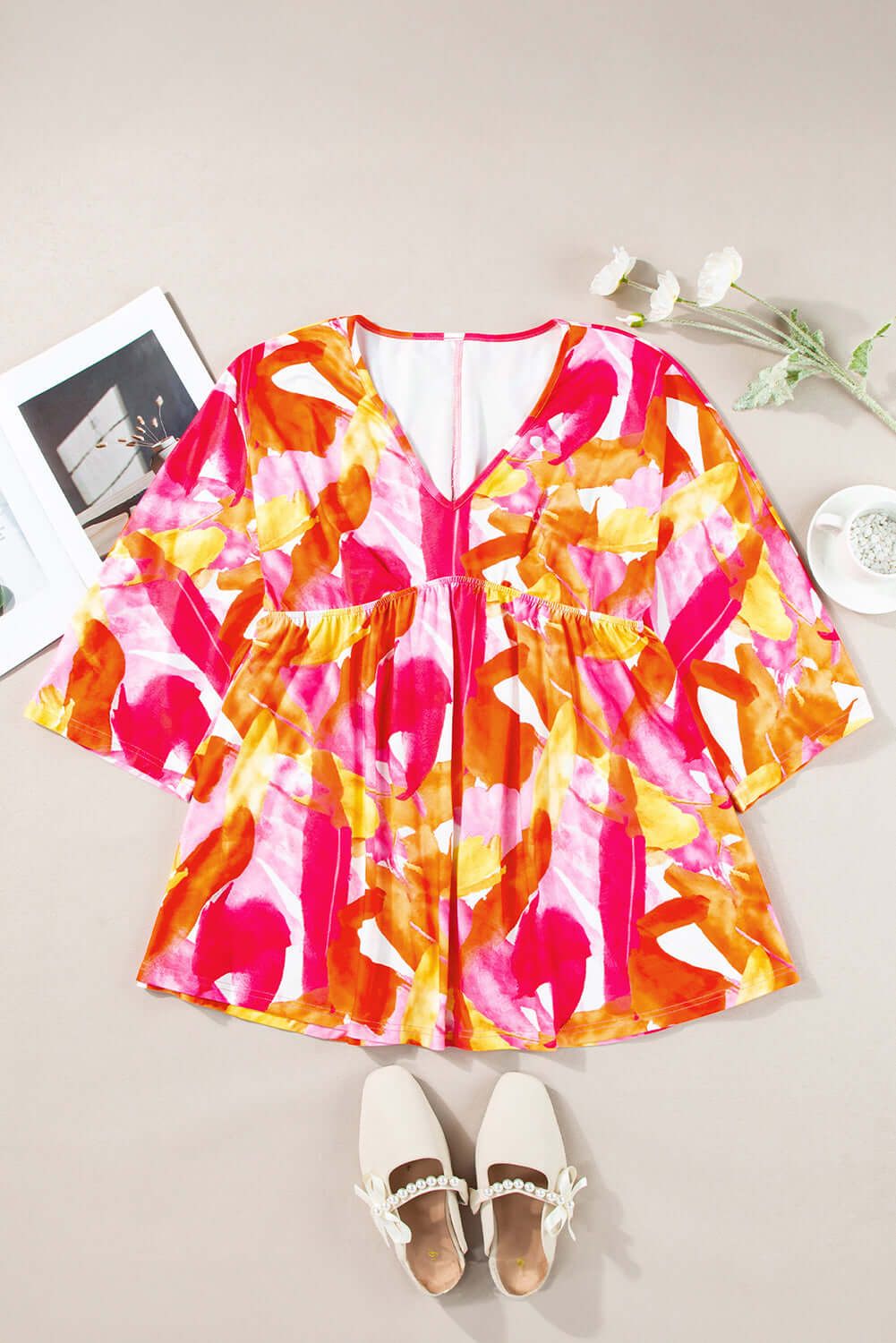 SUNKISSED BABE TOP with brush stroke design, v-neck, 3/4 sleeves, and playful babydoll style. Perfect for summer fashion.