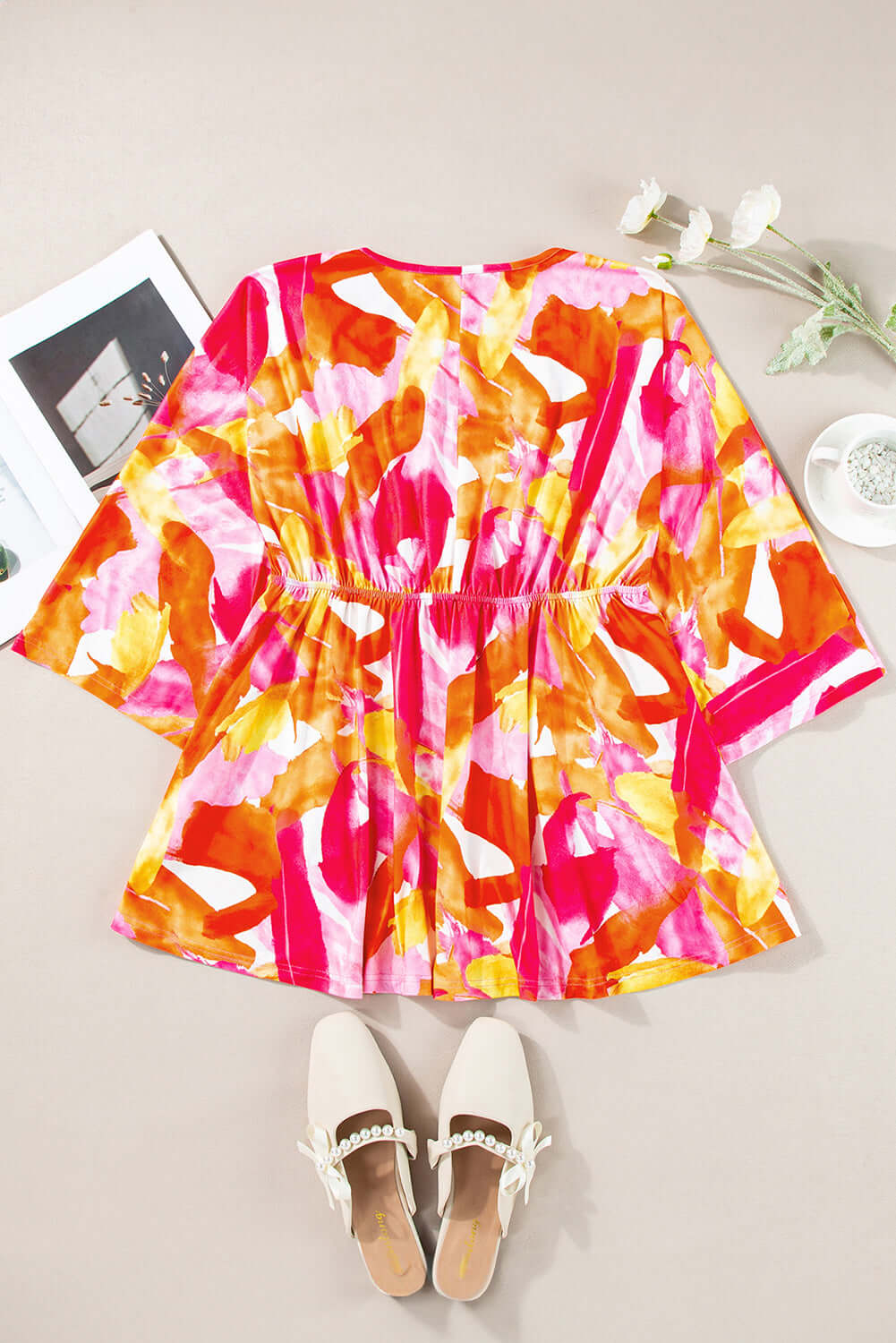 SUNKISSED BABE TOP with vibrant brush stroke design, playful babydoll style, and 3/4 sleeves on a neutral background.