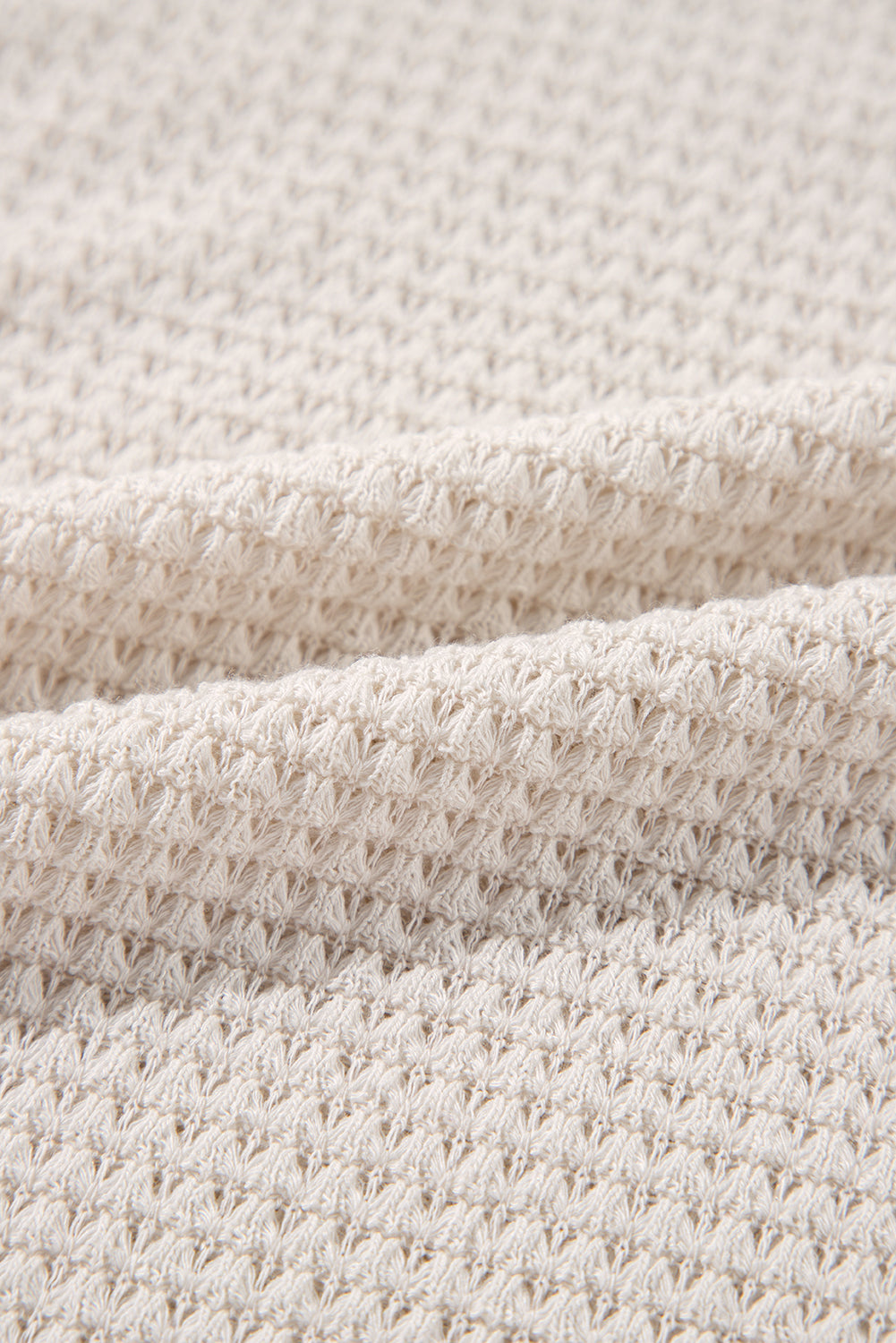 Vanilla waffle knit fabric texture of Finally Made It Top, showcasing its soft, stretchy materials and unique design pattern.