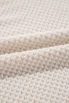 Vanilla waffle knit fabric texture of Finally Made It Top, showcasing its soft, stretchy materials and unique design pattern.