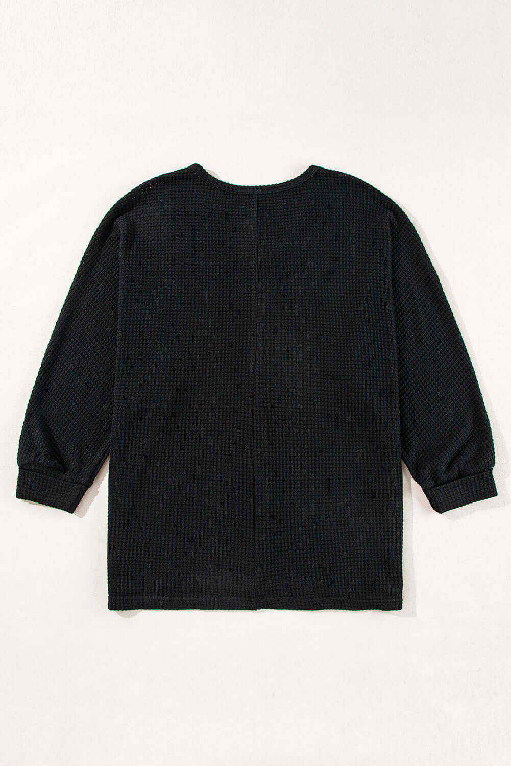 Back view of the black Finally Made It top featuring a soft waffle knit design and loose fit.