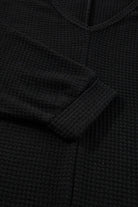 Close-up of the Finally Made It black top, showcasing its soft waffle knit texture and elegant V-neckline.