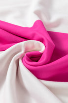 Fuchsia and white fabric swatch in a twisted drape showing bold color contrast.