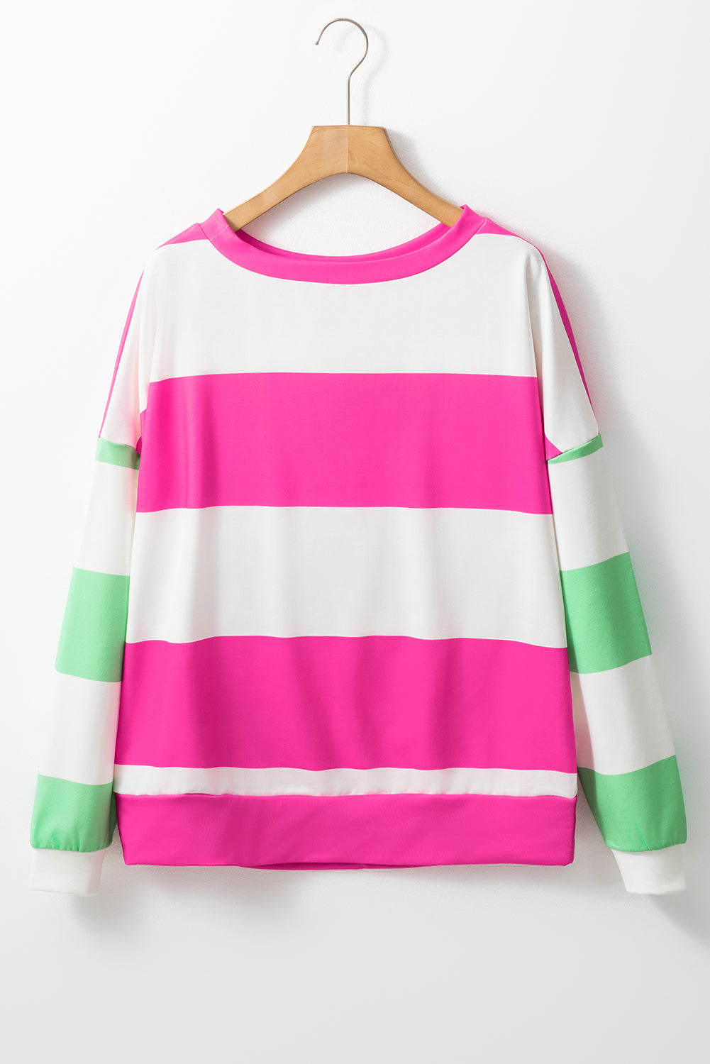 Fuchsia and green color block stripe top with long sleeves and drop shoulder design on wooden hanger