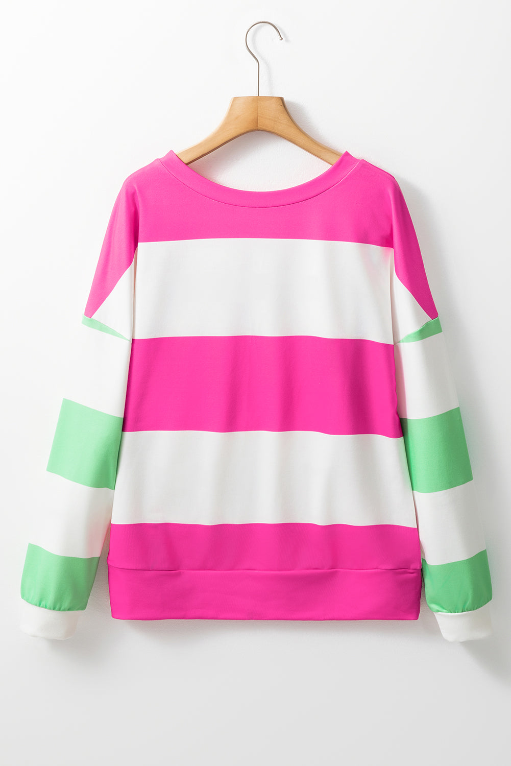 Fuchsia and green color block striped top with long sleeves, featuring a relaxed drop shoulder design on hanger. Perfect for casual wear.