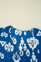 Close-up of Follow The Music boho chic V-neck blouse in vibrant cobalt blue pattern.