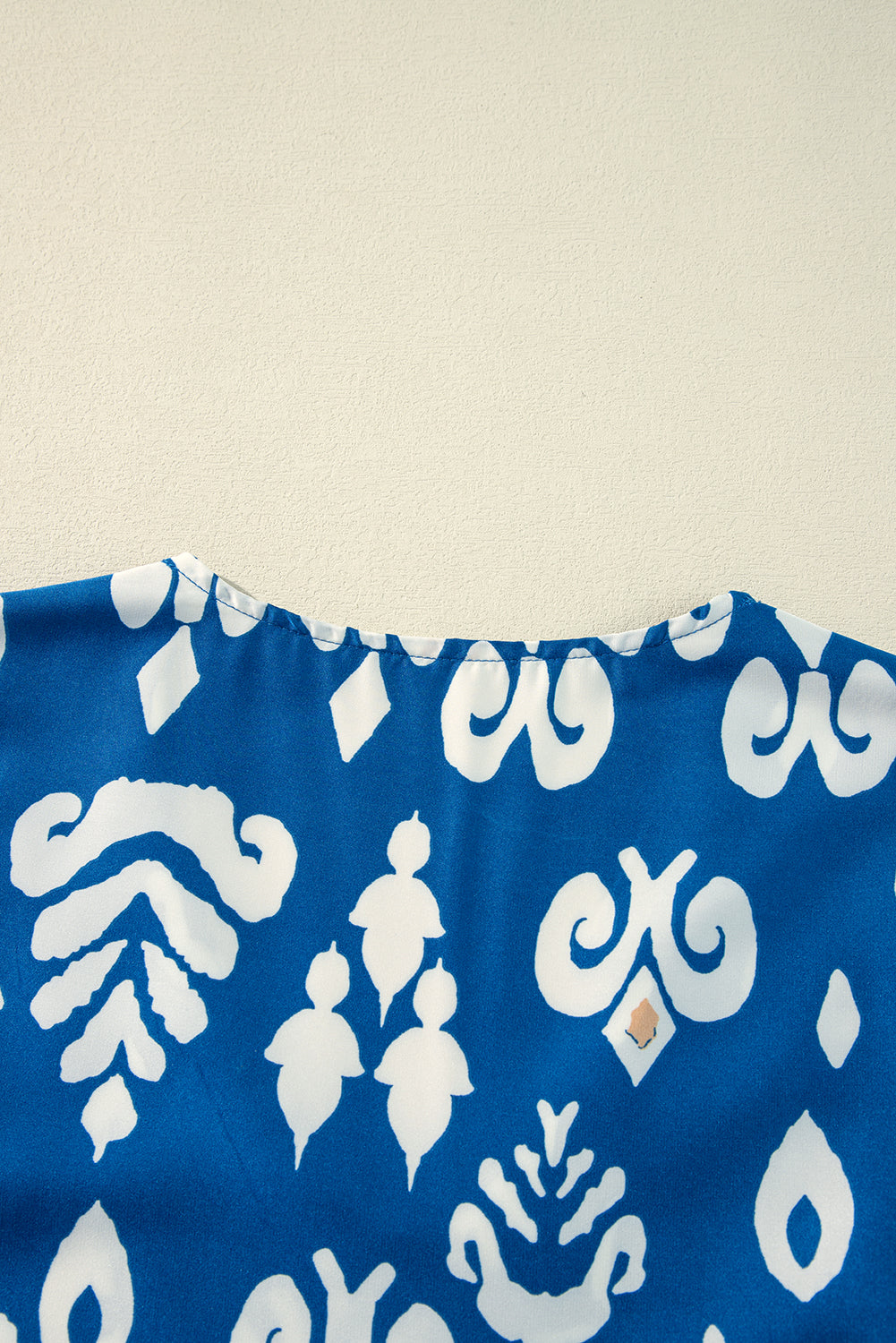 Back view of the Follow The Music boho chic blouse in vibrant cobalt blue with white patterns.