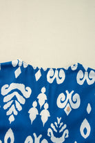 Back view of the Follow The Music boho chic blouse in vibrant cobalt blue with white patterns.