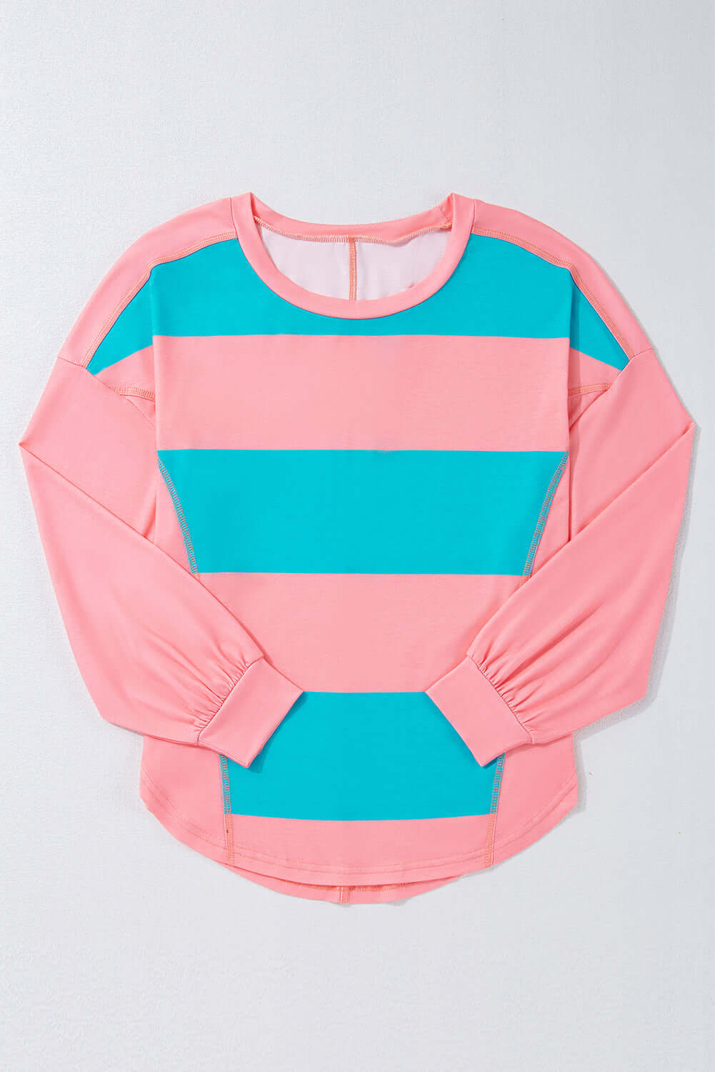 Blue and pink crew neck top with color block design and drop shoulder style, featuring a playful striped pattern.