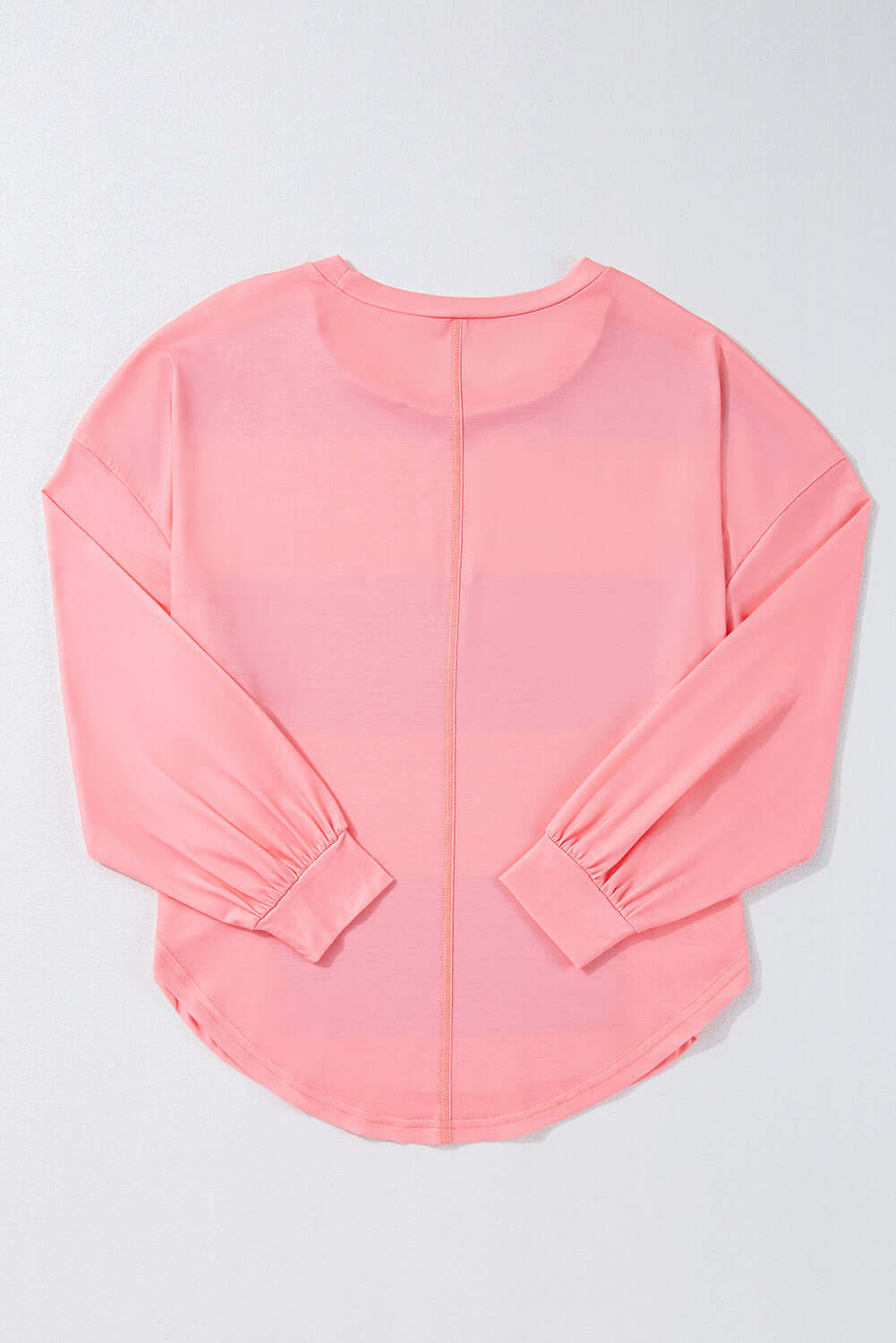 Pink drop shoulder crew neck top with long sleeves and vibrant color block design for stylish layering and accessorizing.