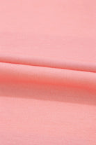 Pink fabric close-up showing smooth texture and soft material.