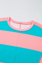 Blue and pink color block crew neck top with striped pattern and drop shoulder design, ideal for versatile layering and accessorizing.