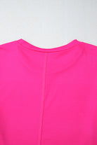 Vibrant pink crew neck top with seam detail, made from polyester and elastane, showcasing a trendy and playful design.